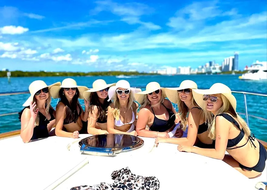 Happy female passengers cruising on one of Enjoy's yachts, off the coast of Miami.